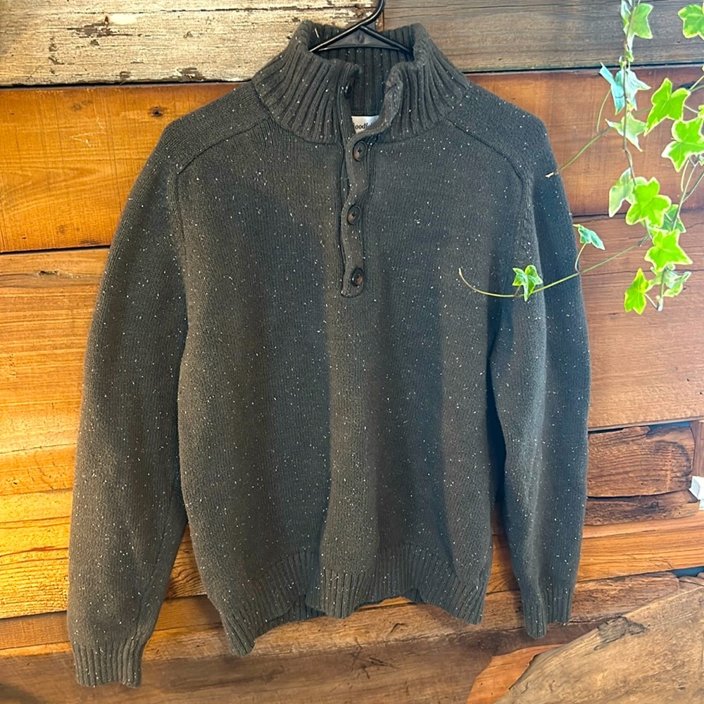 Olive green sweater with wood style buttons and white stitching